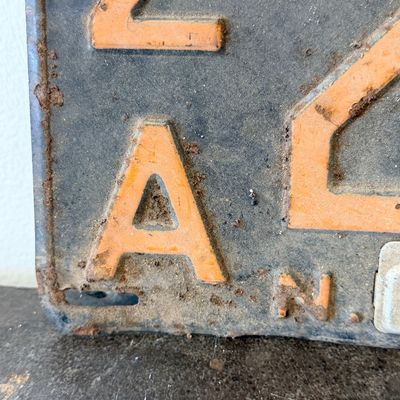 Sale Photo Thumbnail #45: Matching pair of vintage 1956 New Jersey metal license plates, registration number ZA 23F. Each plate features embossed orange characters on a dark background with an attached metal '56' tab (stamped 1665727). Both plates show significant age, surface rus