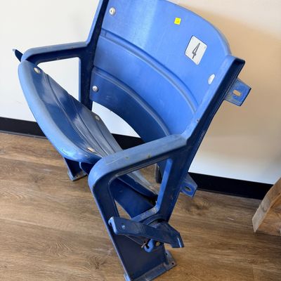 Sale Photo Thumbnail #30: Original blue stadium seat #4 from Veterans Stadium, former home of the Philadelphia Phillies and Eagles. Features molded plastic seat and back with heavy-duty metal frame/supports and metal seat number plate. Includes Certificate of Authenticity signed b