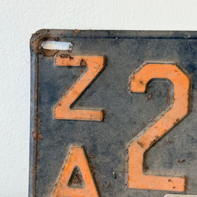 Sale Photo Thumbnail #42: Matching pair of vintage 1956 New Jersey metal license plates, registration number ZA 23F. Each plate features embossed orange characters on a dark background with an attached metal '56' tab (stamped 1665727). Both plates show significant age, surface rus