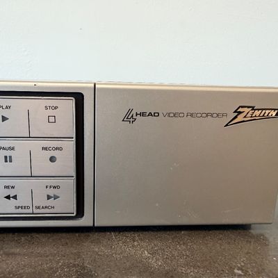 Sale Photo Thumbnail #18: Vintage Zenith 4-Head VHS HQ video cassette recorder (VCR), model VR 1825. Features a simulated wood grain cabinet, front drop-down control panel with timer programming instructions, RCA video/audio inputs and outputs, and coaxial antenna connections. Ser