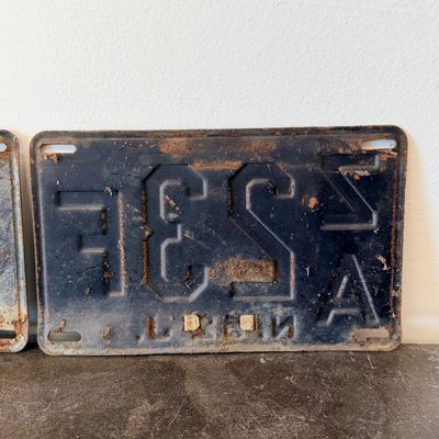 Sale Photo Thumbnail #54: Matching pair of vintage 1956 New Jersey metal license plates, registration number ZA 23F. Each plate features embossed orange characters on a dark background with an attached metal '56' tab (stamped 1665727). Both plates show significant age, surface rus