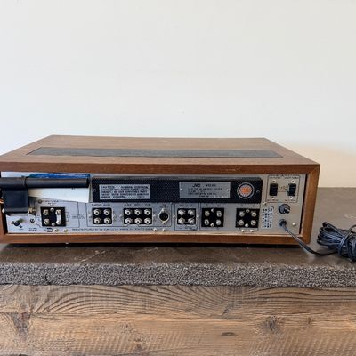 Sale Photo Thumbnail #11: Vintage JVC Model 5020 FM/AM stereo receiver featuring a built-in S.E.A. equalizer control system. Encased in a wood cabinet with a black front panel, illuminated green tuner display, and brushed metal accent trim. Manufactured by Victor Co. of Japan, Ltd