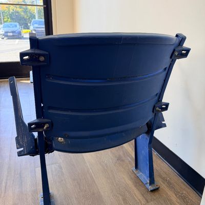 Sale Photo Thumbnail #36: Original blue stadium seat #4 from Veterans Stadium, former home of the Philadelphia Phillies and Eagles. Features molded plastic seat and back with heavy-duty metal frame/supports and metal seat number plate. Includes Certificate of Authenticity signed b