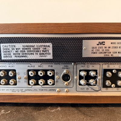 Sale Photo Thumbnail #13: Vintage JVC Model 5020 FM/AM stereo receiver featuring a built-in S.E.A. equalizer control system. Encased in a wood cabinet with a black front panel, illuminated green tuner display, and brushed metal accent trim. Manufactured by Victor Co. of Japan, Ltd