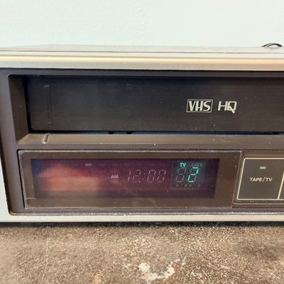 Sale Photo Thumbnail #27: Vintage Zenith 4-Head VHS HQ video cassette recorder (VCR), model VR 1825. Features a simulated wood grain cabinet, front drop-down control panel with timer programming instructions, RCA video/audio inputs and outputs, and coaxial antenna connections. Ser