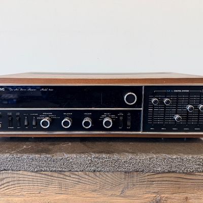 Sale Photo Thumbnail #4: Vintage JVC Model 5020 FM/AM stereo receiver featuring a built-in S.E.A. equalizer control system. Encased in a wood cabinet with a black front panel, illuminated green tuner display, and brushed metal accent trim. Manufactured by Victor Co. of Japan, Ltd