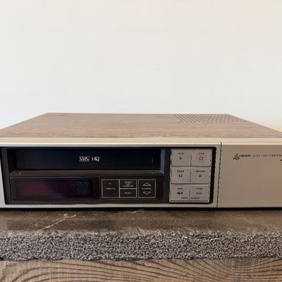 Sale Photo Thumbnail #15: Vintage Zenith 4-Head VHS HQ video cassette recorder (VCR), model VR 1825. Features a simulated wood grain cabinet, front drop-down control panel with timer programming instructions, RCA video/audio inputs and outputs, and coaxial antenna connections. Ser