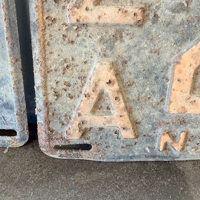 Sale Photo Thumbnail #51: Matching pair of vintage 1956 New Jersey metal license plates, registration number ZA 23F. Each plate features embossed orange characters on a dark background with an attached metal '56' tab (stamped 1665727). Both plates show significant age, surface rus