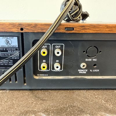 Sale Photo Thumbnail #25: Vintage Zenith 4-Head VHS HQ video cassette recorder (VCR), model VR 1825. Features a simulated wood grain cabinet, front drop-down control panel with timer programming instructions, RCA video/audio inputs and outputs, and coaxial antenna connections. Ser