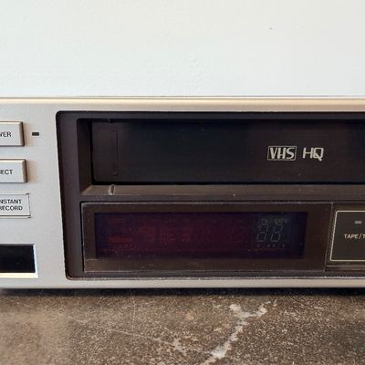 Sale Photo Thumbnail #16: Vintage Zenith 4-Head VHS HQ video cassette recorder (VCR), model VR 1825. Features a simulated wood grain cabinet, front drop-down control panel with timer programming instructions, RCA video/audio inputs and outputs, and coaxial antenna connections. Ser