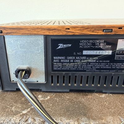 Sale Photo Thumbnail #24: Vintage Zenith 4-Head VHS HQ video cassette recorder (VCR), model VR 1825. Features a simulated wood grain cabinet, front drop-down control panel with timer programming instructions, RCA video/audio inputs and outputs, and coaxial antenna connections. Ser