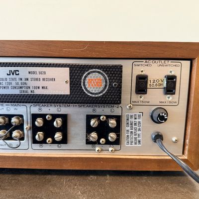 Sale Photo Thumbnail #14: Vintage JVC Model 5020 FM/AM stereo receiver featuring a built-in S.E.A. equalizer control system. Encased in a wood cabinet with a black front panel, illuminated green tuner display, and brushed metal accent trim. Manufactured by Victor Co. of Japan, Ltd