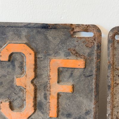 Sale Photo Thumbnail #43: Matching pair of vintage 1956 New Jersey metal license plates, registration number ZA 23F. Each plate features embossed orange characters on a dark background with an attached metal '56' tab (stamped 1665727). Both plates show significant age, surface rus