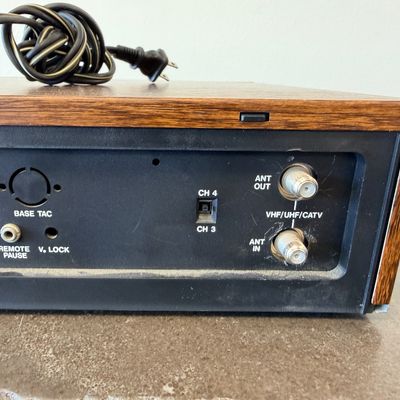 Sale Photo Thumbnail #26: Vintage Zenith 4-Head VHS HQ video cassette recorder (VCR), model VR 1825. Features a simulated wood grain cabinet, front drop-down control panel with timer programming instructions, RCA video/audio inputs and outputs, and coaxial antenna connections. Ser