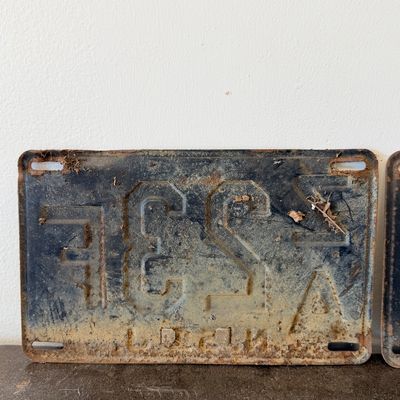 Sale Photo Thumbnail #53: Matching pair of vintage 1956 New Jersey metal license plates, registration number ZA 23F. Each plate features embossed orange characters on a dark background with an attached metal '56' tab (stamped 1665727). Both plates show significant age, surface rus