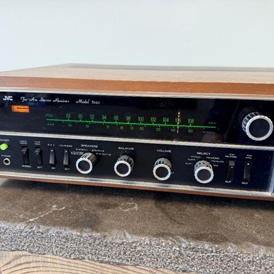 Sale Photo Thumbnail #2: Vintage JVC Model 5020 FM/AM stereo receiver featuring a built-in S.E.A. equalizer control system. Encased in a wood cabinet with a black front panel, illuminated green tuner display, and brushed metal accent trim. Manufactured by Victor Co. of Japan, Ltd