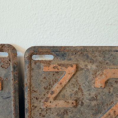 Sale Photo Thumbnail #48: Matching pair of vintage 1956 New Jersey metal license plates, registration number ZA 23F. Each plate features embossed orange characters on a dark background with an attached metal '56' tab (stamped 1665727). Both plates show significant age, surface rus