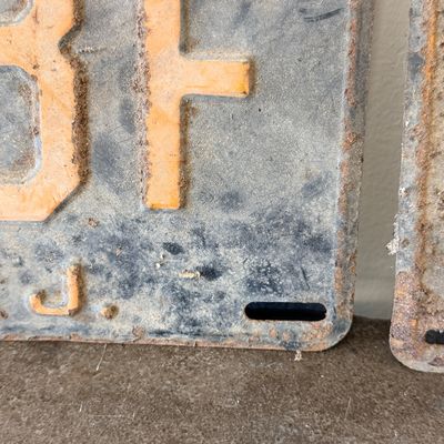 Sale Photo Thumbnail #44: Matching pair of vintage 1956 New Jersey metal license plates, registration number ZA 23F. Each plate features embossed orange characters on a dark background with an attached metal '56' tab (stamped 1665727). Both plates show significant age, surface rus