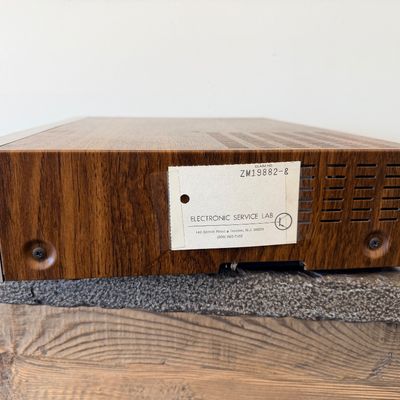 Sale Photo Thumbnail #22: Vintage Zenith 4-Head VHS HQ video cassette recorder (VCR), model VR 1825. Features a simulated wood grain cabinet, front drop-down control panel with timer programming instructions, RCA video/audio inputs and outputs, and coaxial antenna connections. Ser