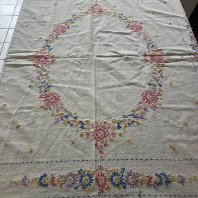 Multicolored Floral Embroidery and Blue Cross-Stitched Linens