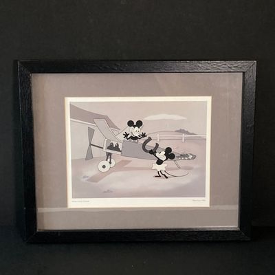 LOT 59: Framed Walt Disney Good Luck Charm / Plane Crazy 1928 Print with Souvenir Mickey Mouse and Collection of Books