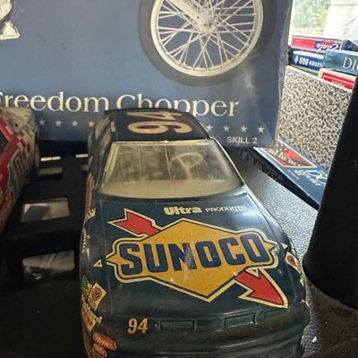Vintage plastic Sunoco #94 Sterling Marlin NASCAR model car with some surface dust and wear.
