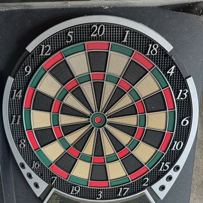 Halex electronic dartboard housed in a black wooden cabinet, featuring soft-tip segments and a digital scoring display.