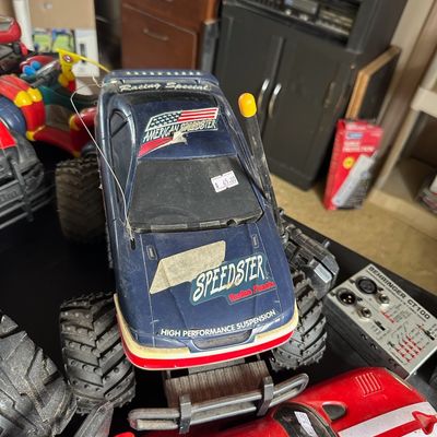 Vintage Radio Shack 'American Speedster' remote control monster truck, showing moderate play wear, surrounded by other toy...
