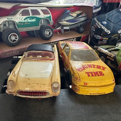 Collection of vintage toy cars and die-cast vehicles, including a yellow Country Time NASCAR stock car, a vintage plastic convertible,...