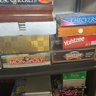 Assortment of vintage and modern board games including Deluxe Edition Monopoly, Yahtzee 40th Anniversary, Chinese Checkers, and Domino...