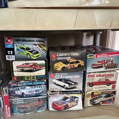 Collection of vintage boxed plastic model car kits by AMT, Revell, Monogram, and MPC, featuring classic American muscle cars, NASCAR...