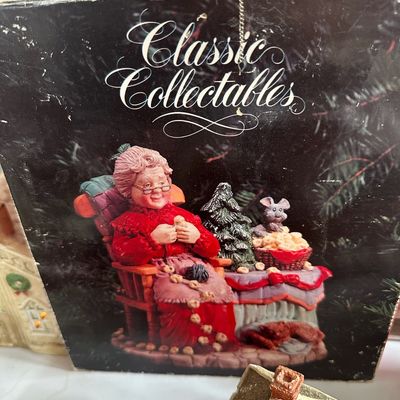 Classic Collectables Mrs. Claus figurine in original box, depicting Mrs. Claus stringing popcorn in a rocking chair alongside miniature...