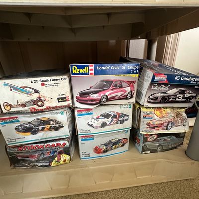 Collection of vintage boxed model car kits from Revell and Monogram, featuring NASCAR stock cars, a Honda Civic Si Coupe, and a funny car.