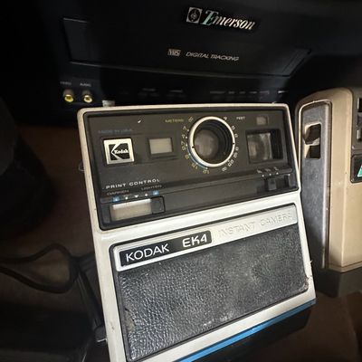 Vintage Kodak EK4 instant camera, produced in the late 1970s, shown in front of an Emerson CRT television.
