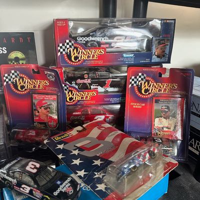Collection of Dale Earnhardt NASCAR die-cast cars and memorabilia, including packaged Winner's Circle and Revell 1:64 and 1:24 scale...