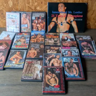 23 Adult DVDs and a book titled "International Mr. Leather: 25 Years of Champions" 