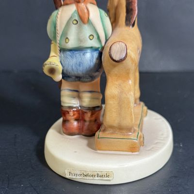LOT 109: Set of 3 Goebel Hummel Figures - Pray Before Battle, Angel with Lantern, and Good Friends Girl with Lamb