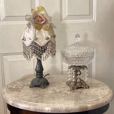 LOT 66: Wood Accent Table with Faux Marble Top, Cut Glass Pedestal Lidded Candy Dish and Decorative Lamp