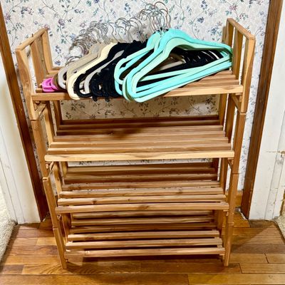LOT 119: Set of 4 Stackable Cedar Shoe Racks and a Group of Cloth Hanger