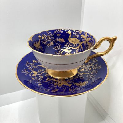 LOT 102: The Peacock Collection - Assorted Peacock Decor (Tracy Porter Serving Plate, Napkin Holder, Coalport Tea Cup / Saucer) and More