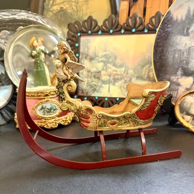 LOT 129: Victorian Christmas Sleigh Ride Decor Including Miniature Wood Sled, Pictures, Plates, Snow-globe and More