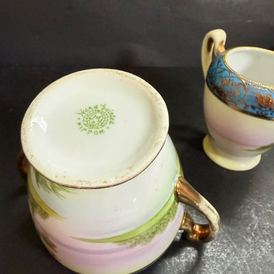 LOT 125: Collection of Painted Nippon Porcelain- Creamers, Pitcher, Plates and More