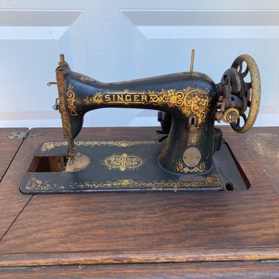 LOT 60: Vintage / Antique Rolling Singer Sewing Machine Cabinet with Wrought Iron Base