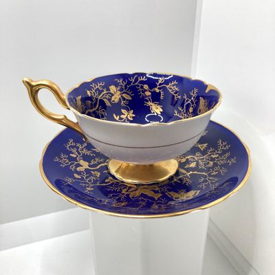 LOT 102: The Peacock Collection - Assorted Peacock Decor (Tracy Porter Serving Plate, Napkin Holder, Coalport Tea Cup / Saucer) and More