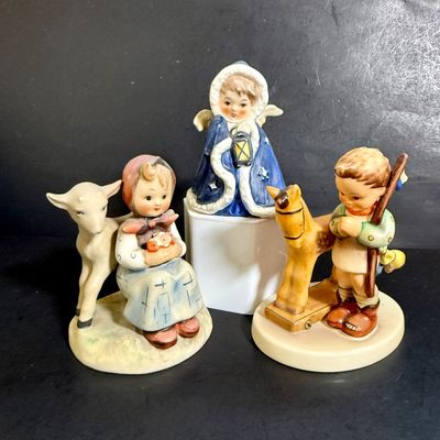 LOT 109: Set of 3 Goebel Hummel Figures - Pray Before Battle, Angel with Lantern, and Good Friends Girl with Lamb