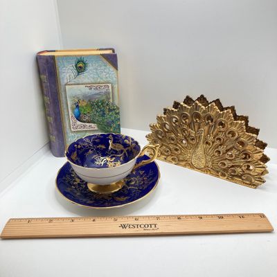 LOT 102: The Peacock Collection - Assorted Peacock Decor (Tracy Porter Serving Plate, Napkin Holder, Coalport Tea Cup / Saucer) and More