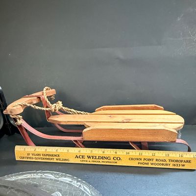 LOT 129: Victorian Christmas Sleigh Ride Decor Including Miniature Wood Sled, Pictures, Plates, Snow-globe and More