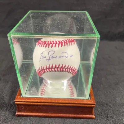 Tommy Lasorda autographed baseball, displayed inside a glass cube case with a wooden base.