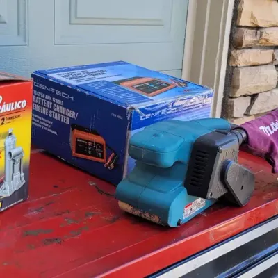 Battery Charger, Makita Sander, and Hydraulic Jack