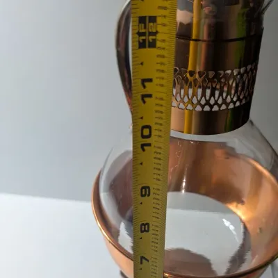 Sale Photo Thumbnail #16: The vintage Princess House copper and brass coffee carafe with stand is a popular 1960s and 1970s mid-century piece designed for elegant tabletop coffee or tea service